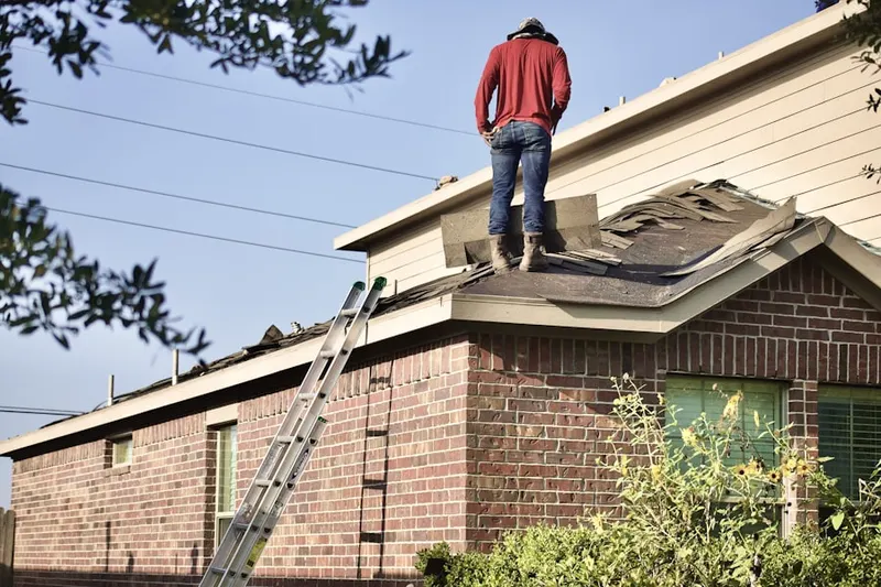 Professional roofer working on a residential roof in La Fontaine
